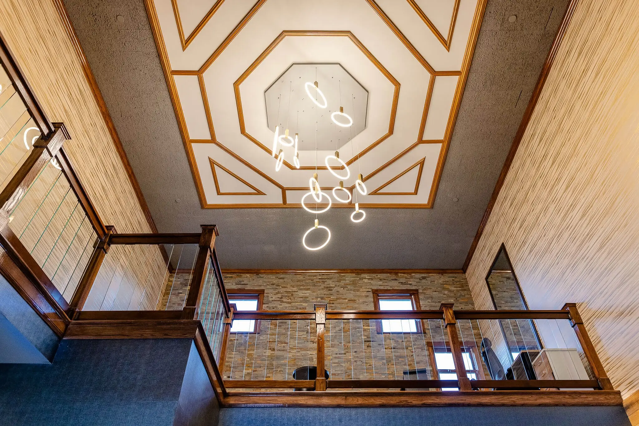 Chateau Merrimack lobby ceiling with modern light installation and balcony